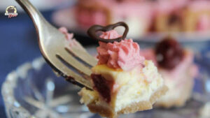 Kirschkäsekuchen mit Schokoherz auf auf einer Gabel