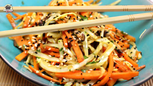 Essstäbchen und Wok-Gemüse in einer türkisfarbenen Schüssel