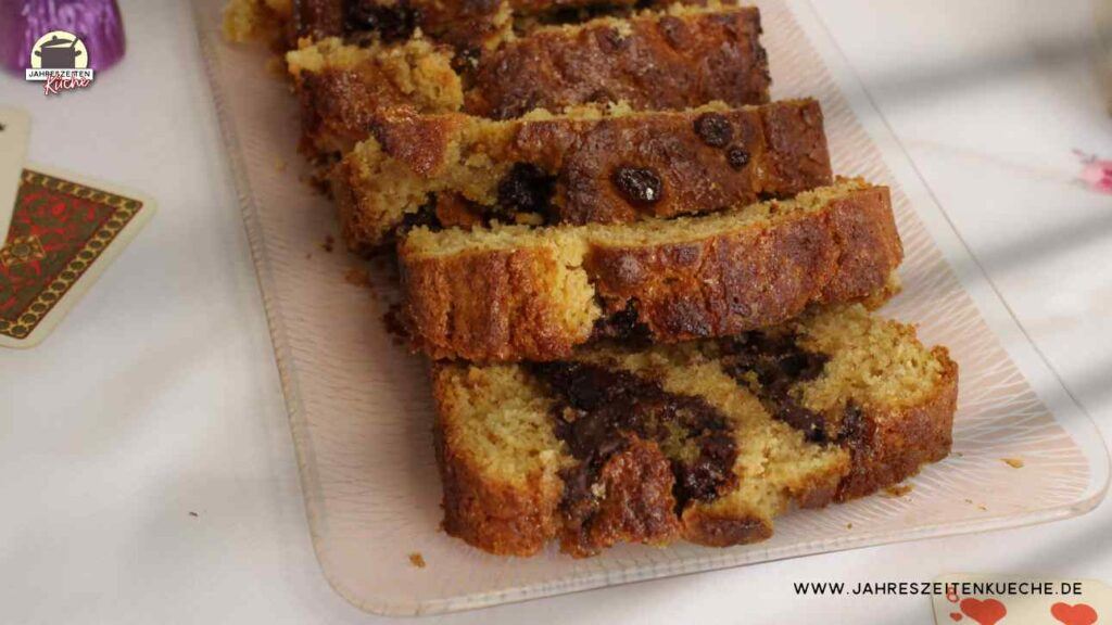 Scheiben von einem fertig gebackenen Kuchen mit Likörpralinen liegen auf einem Glastablett